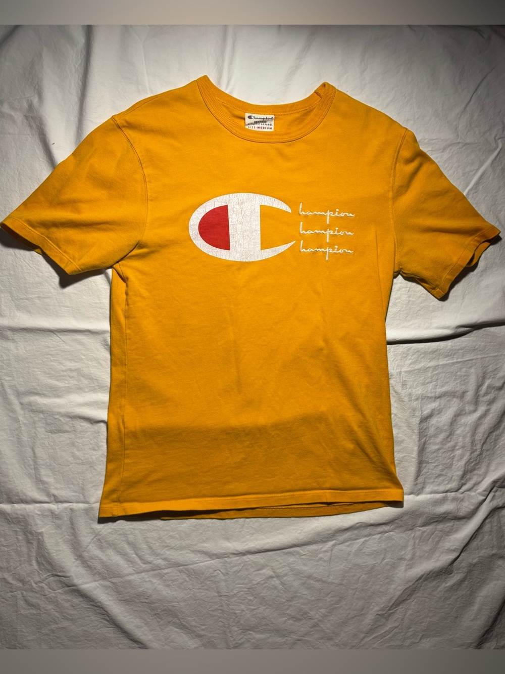 Champion Athletic Apparel Cursive Gold Graphic Logo Tee Men’s Size Medium
